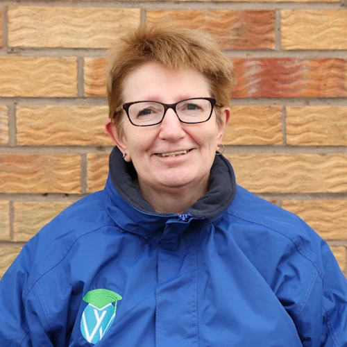 Elizabeth Amos-Milburn wearing uniform in front of the training centre