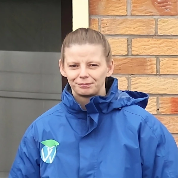 Maria Amos wearing uniform in front of the training centre
