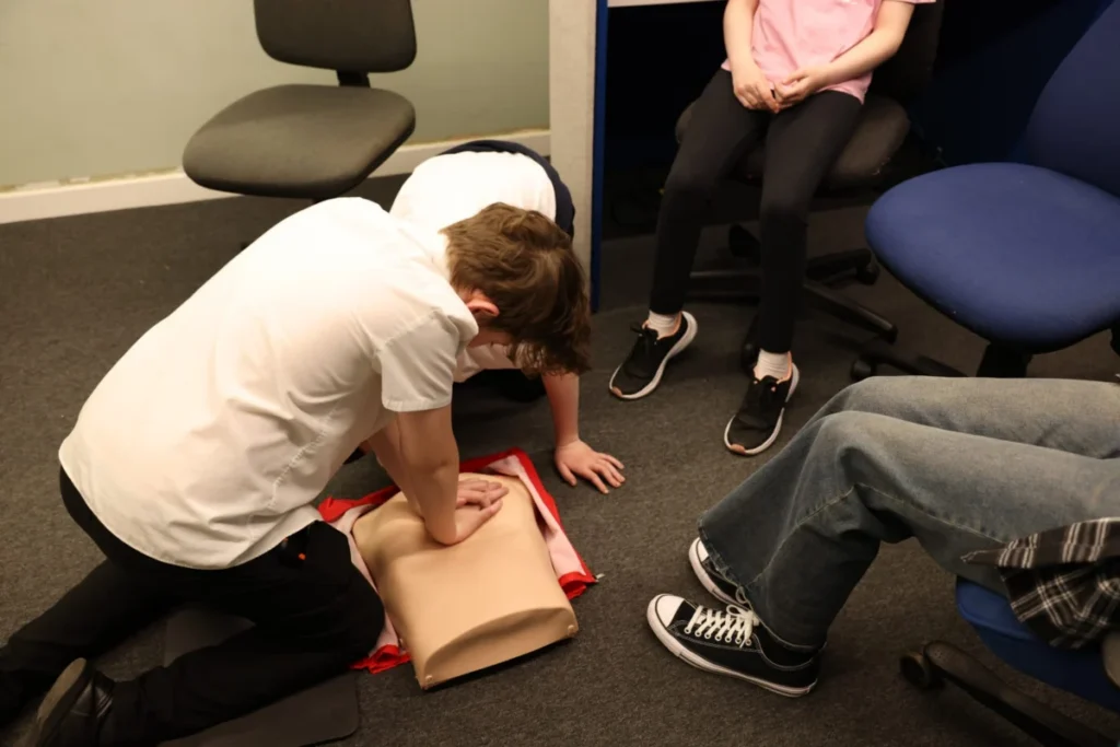 Young people taking part in a hands-on First Aid session
